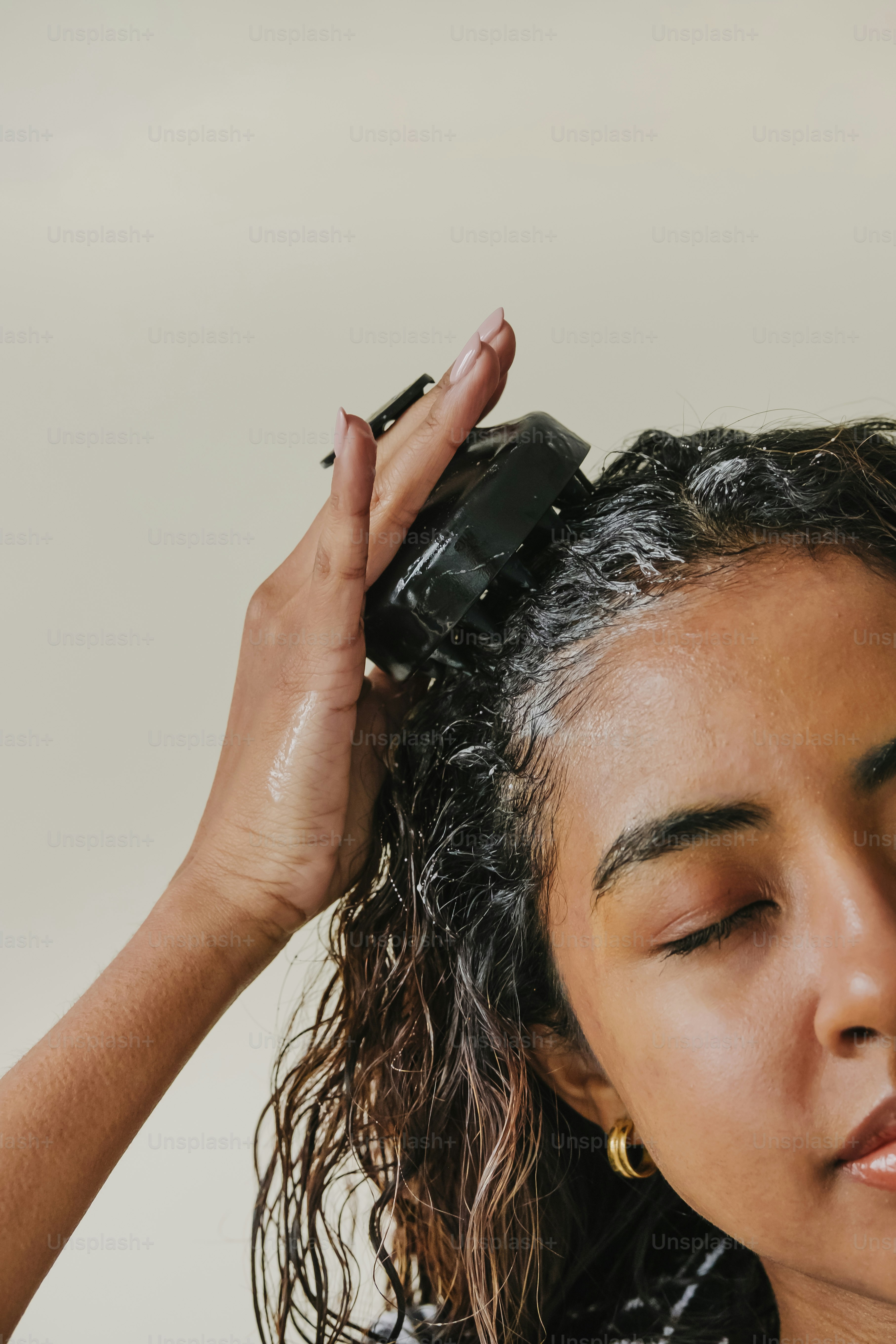 a woman is drying her hair with a hair dryer