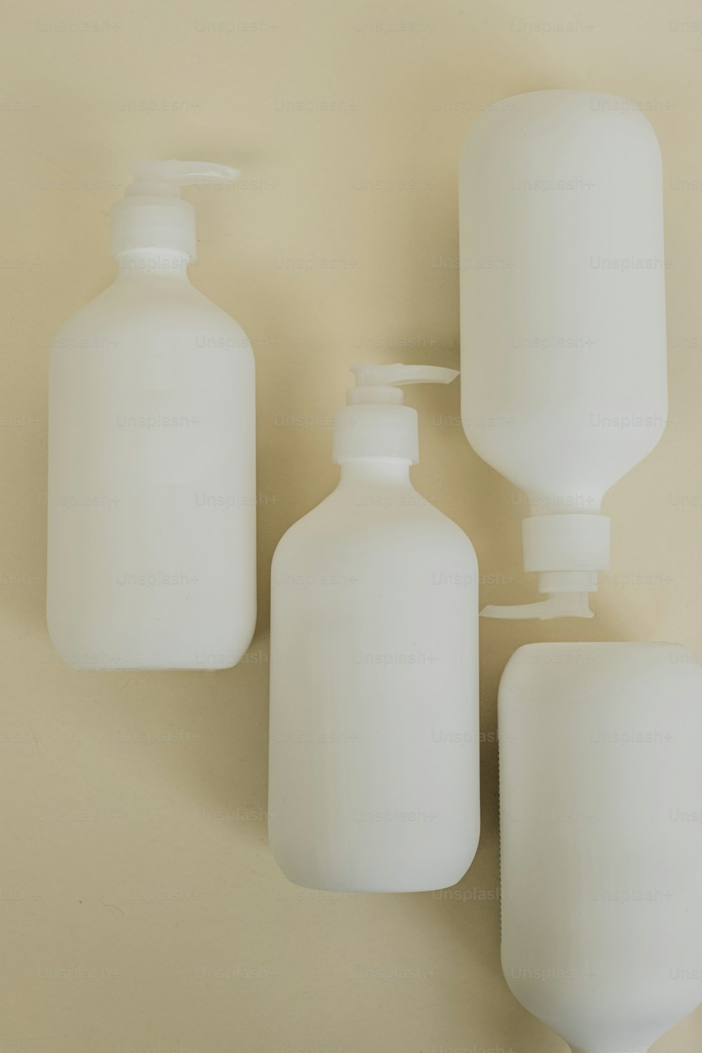 three bottles of soap and a soap dispenser