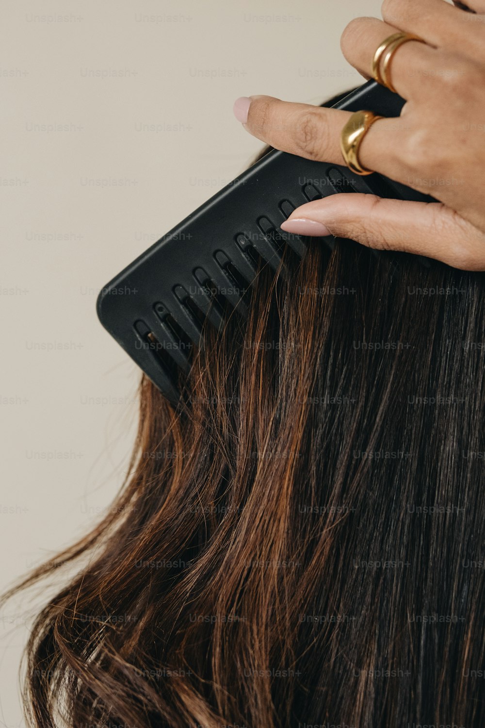 a close up of a person using a hair comb