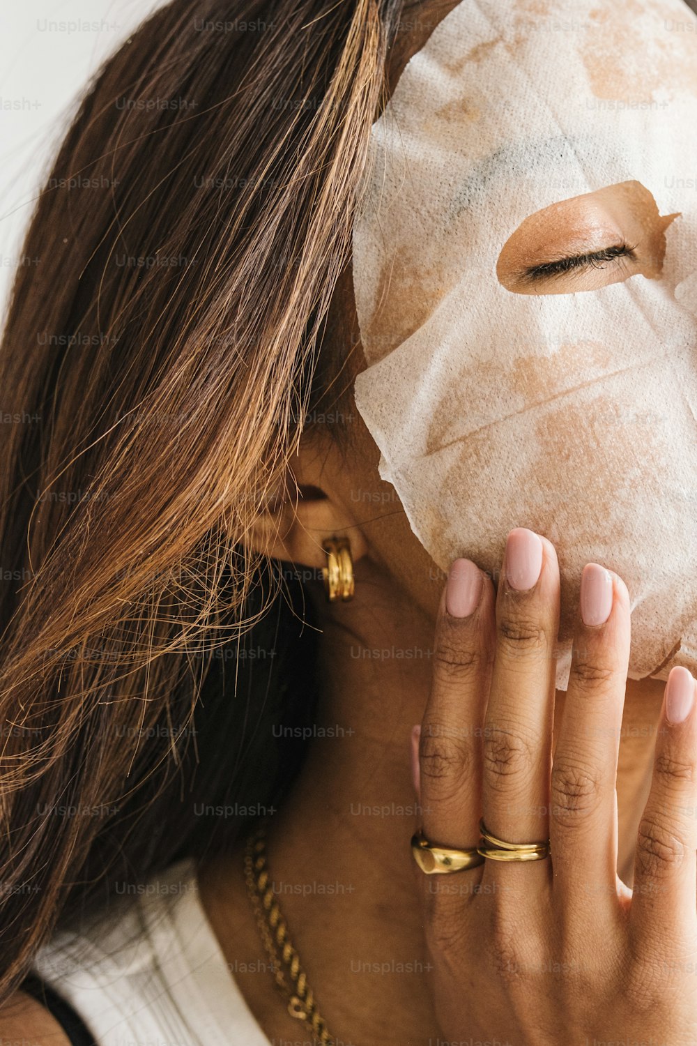a woman with a sheet mask covering her face