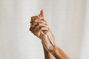 a woman's hands are covered in soap