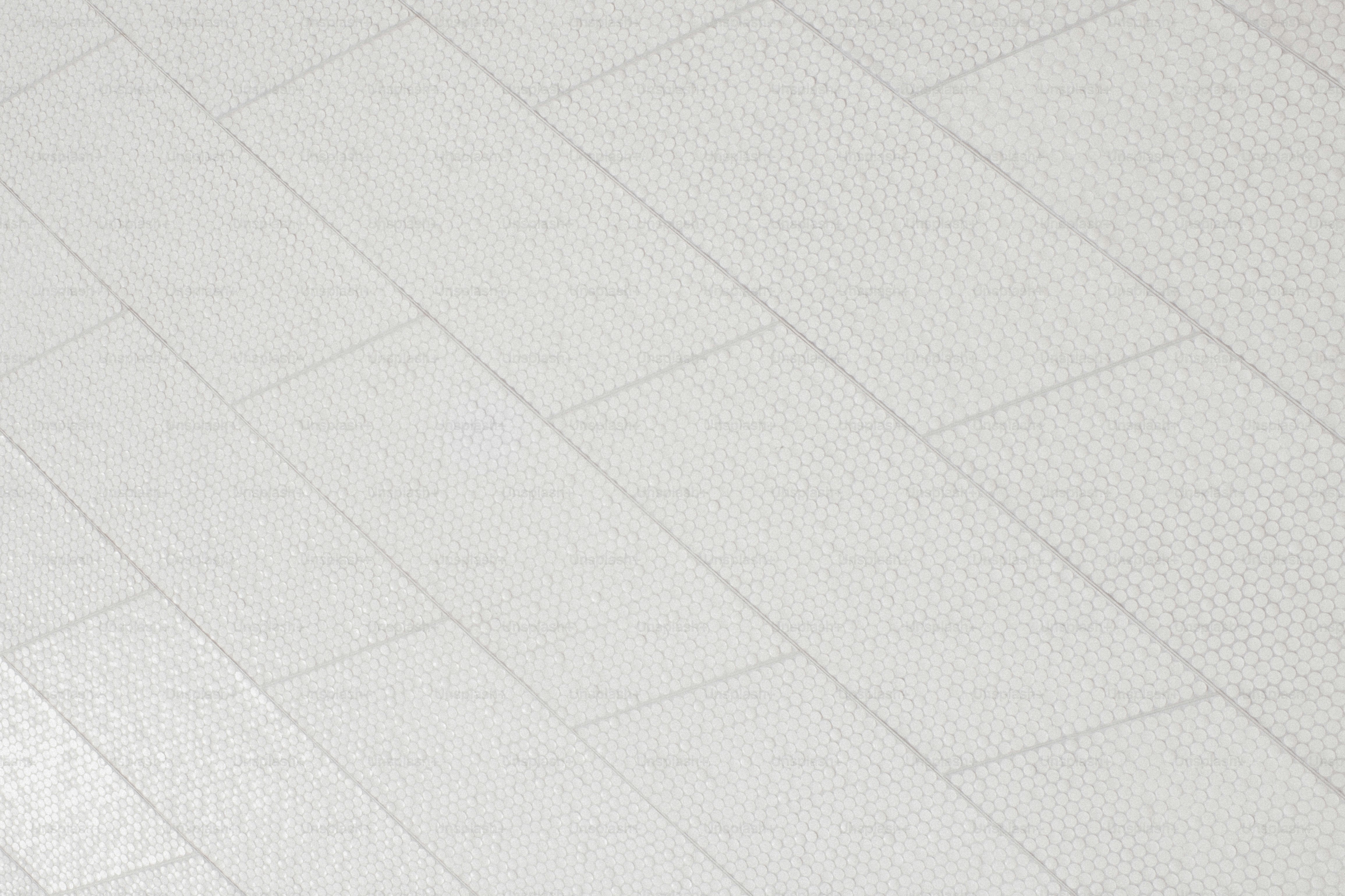a man riding a skateboard on top of a tiled floor