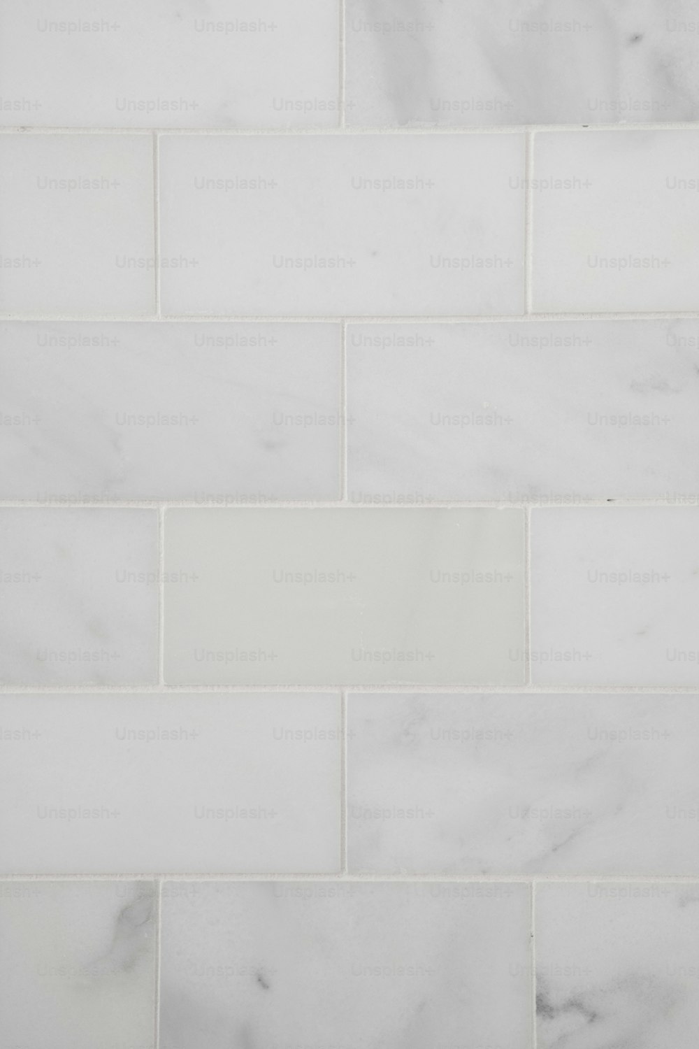 a close up of a white tile wall