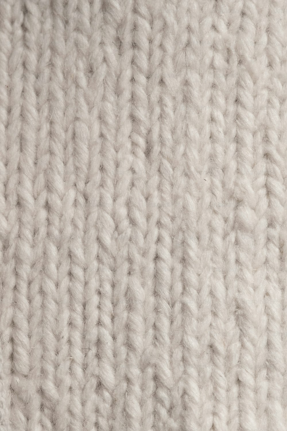 a close up of a white knitted blanket