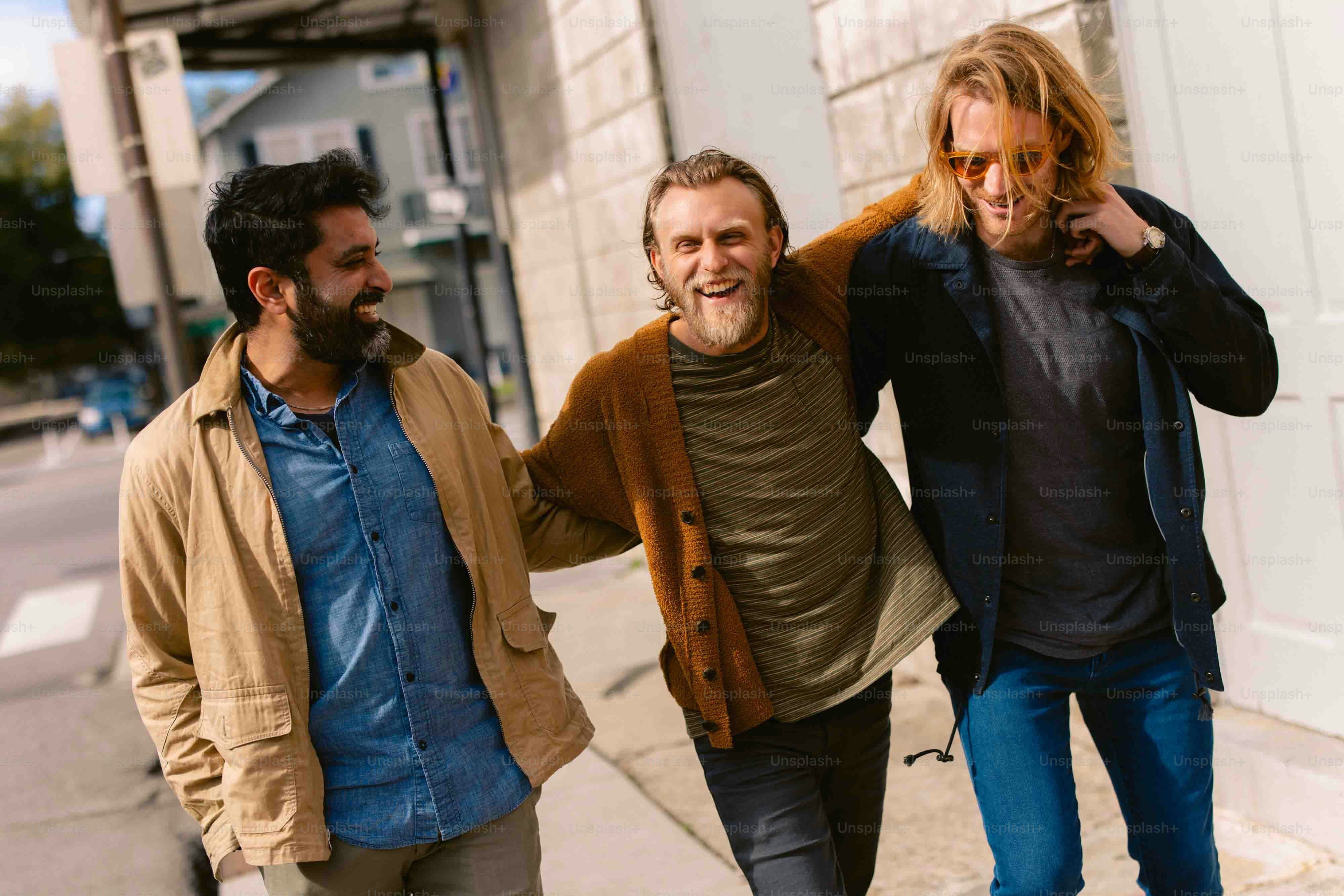 a group of three men walking down a street