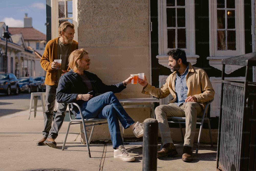a group of people sitting at a table outside of a building