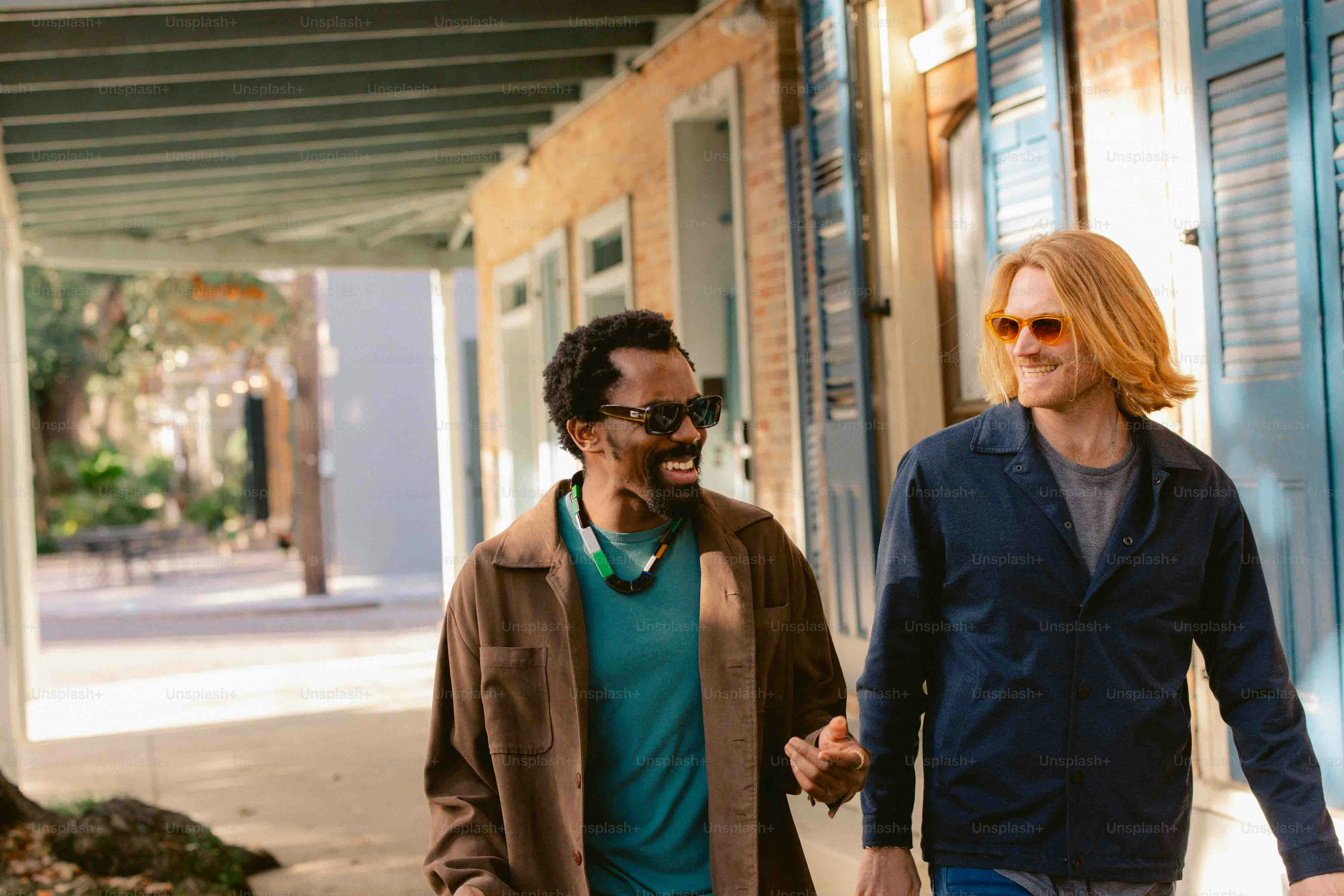 two men walking down a street holding hands