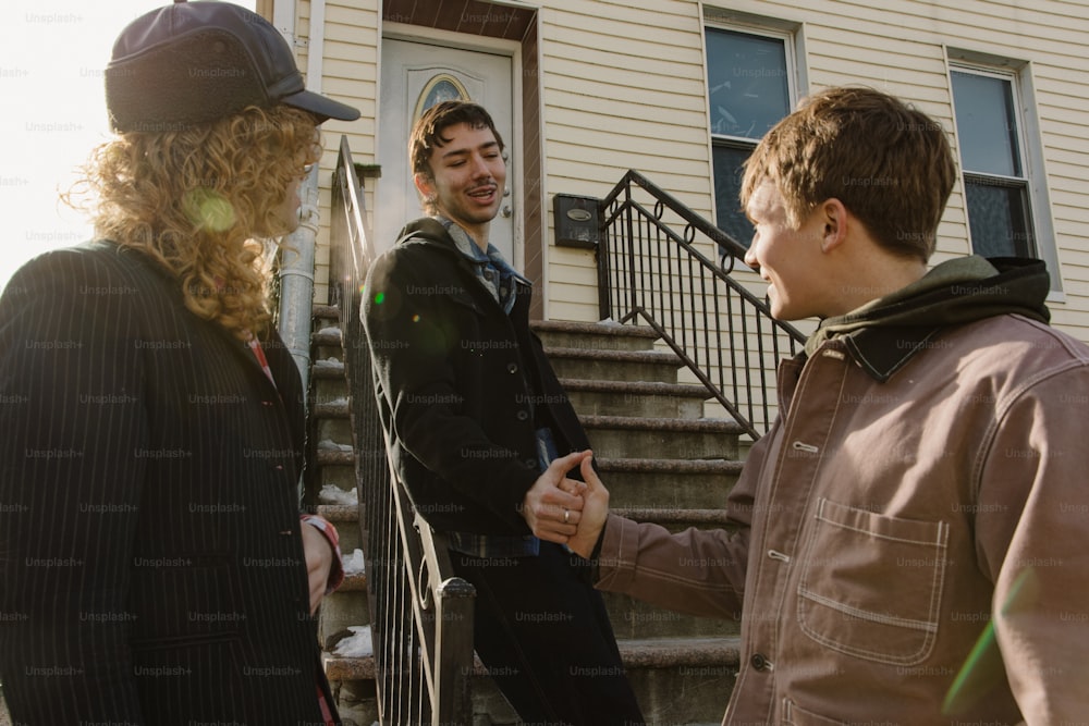 a group of people standing in front of a house