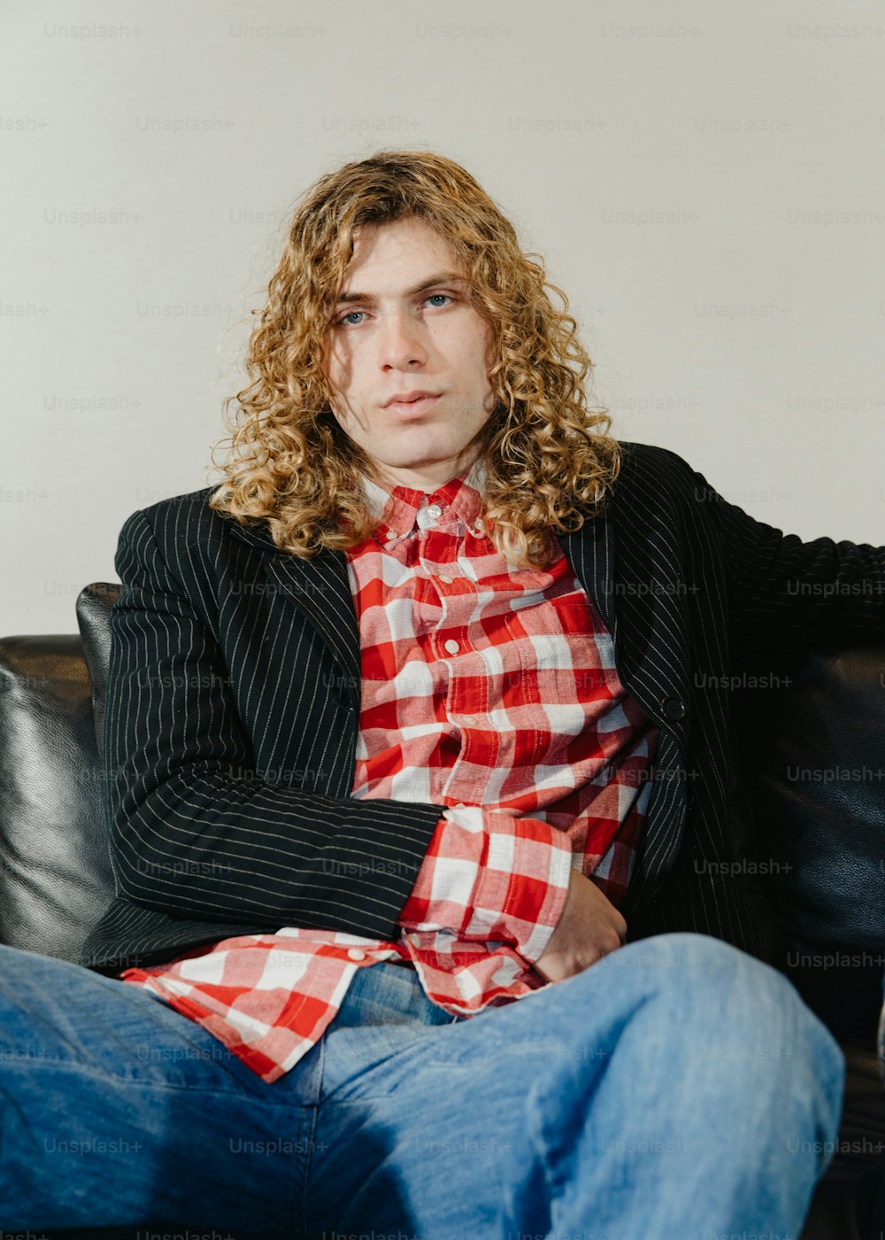 a man sitting on top of a black couch