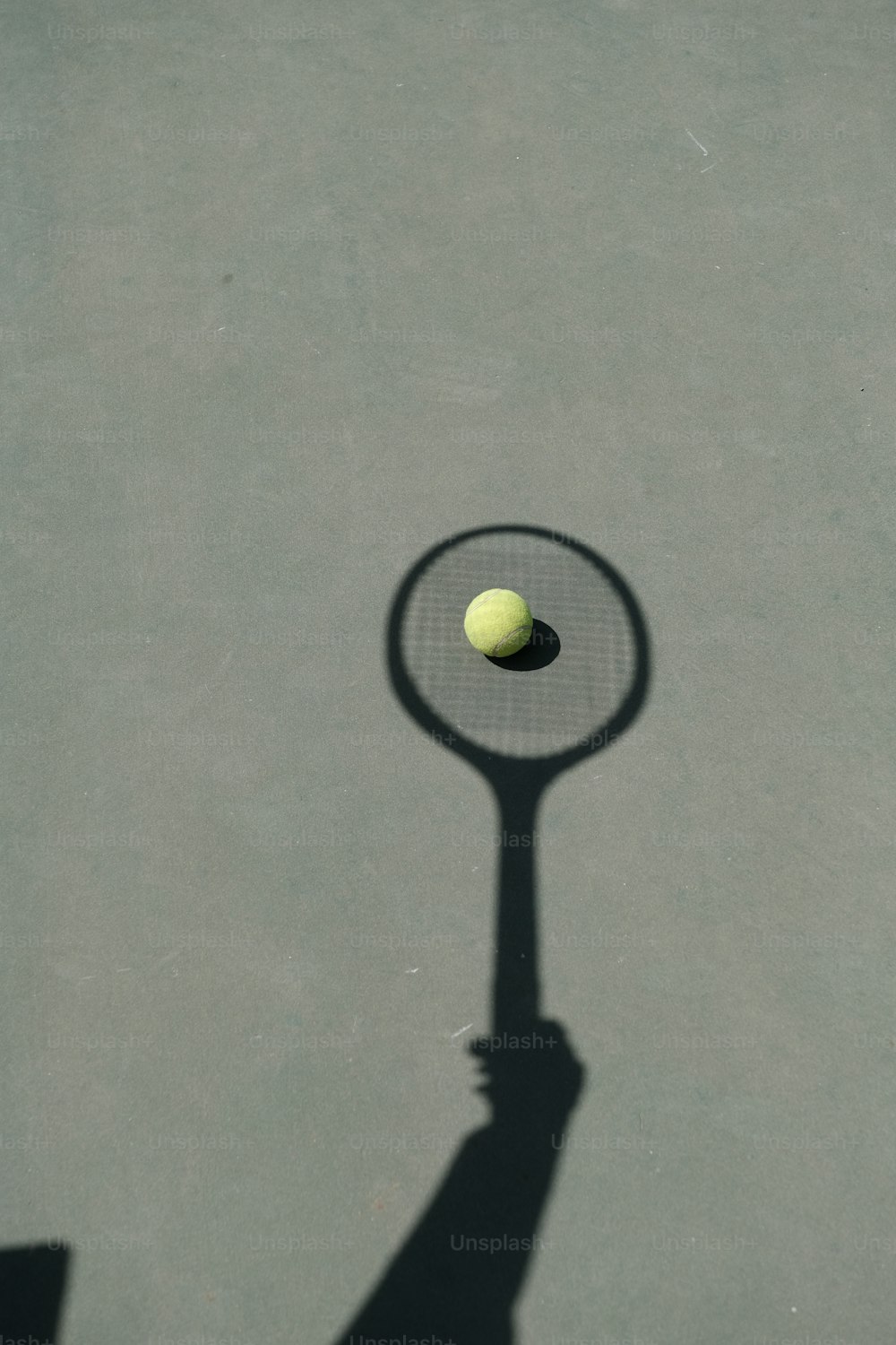 테니스 라켓과 테니스 공을 들고 있는 사람의 그림자
