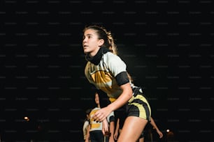 a woman running on a field at night