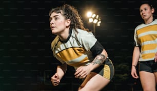 a female soccer player in a yellow and black uniform