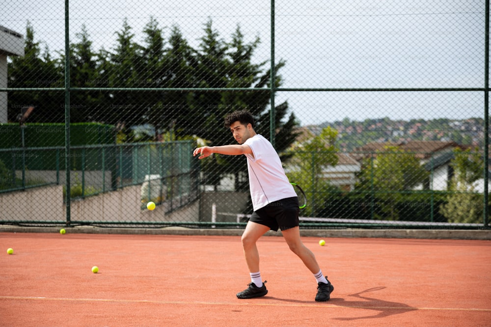 a man swinging a tennis racquet at a tennis ball