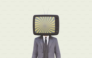 a man wearing a suit and tie standing in front of a tv