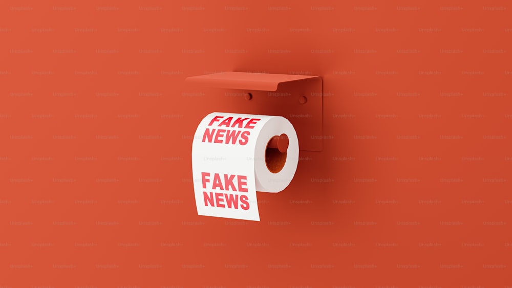 Un rouleau de fake news accroché à un mur rouge