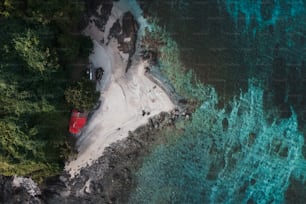 an aerial view of a beach with a red house