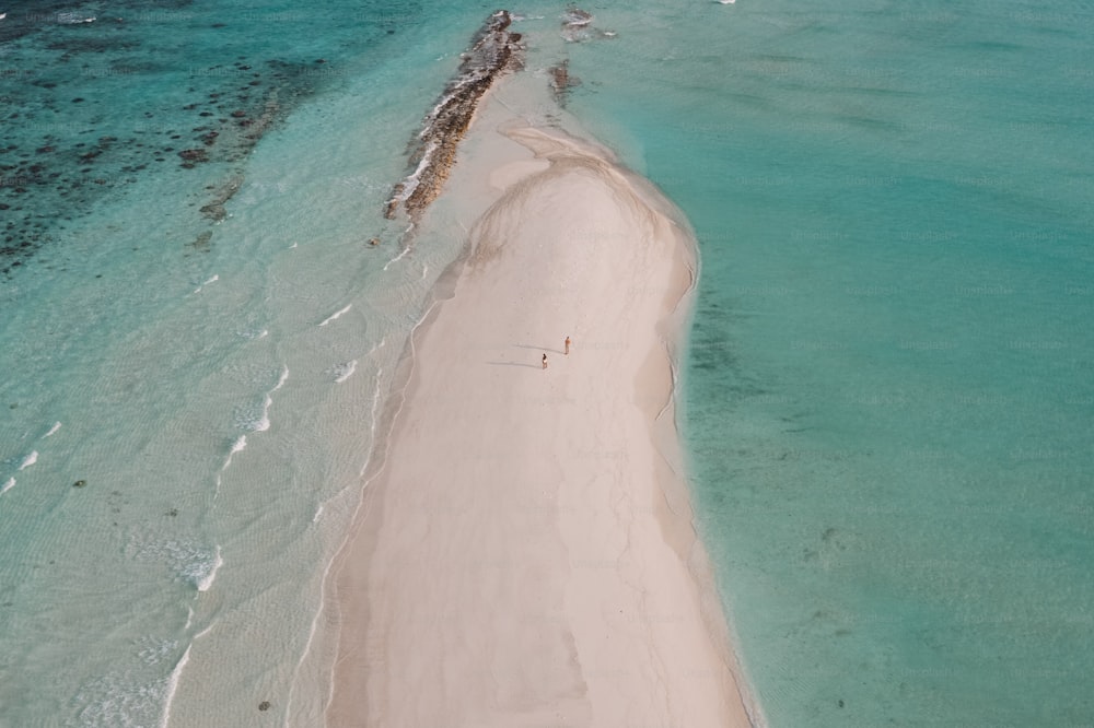 an aerial view of a sandy beach and ocean