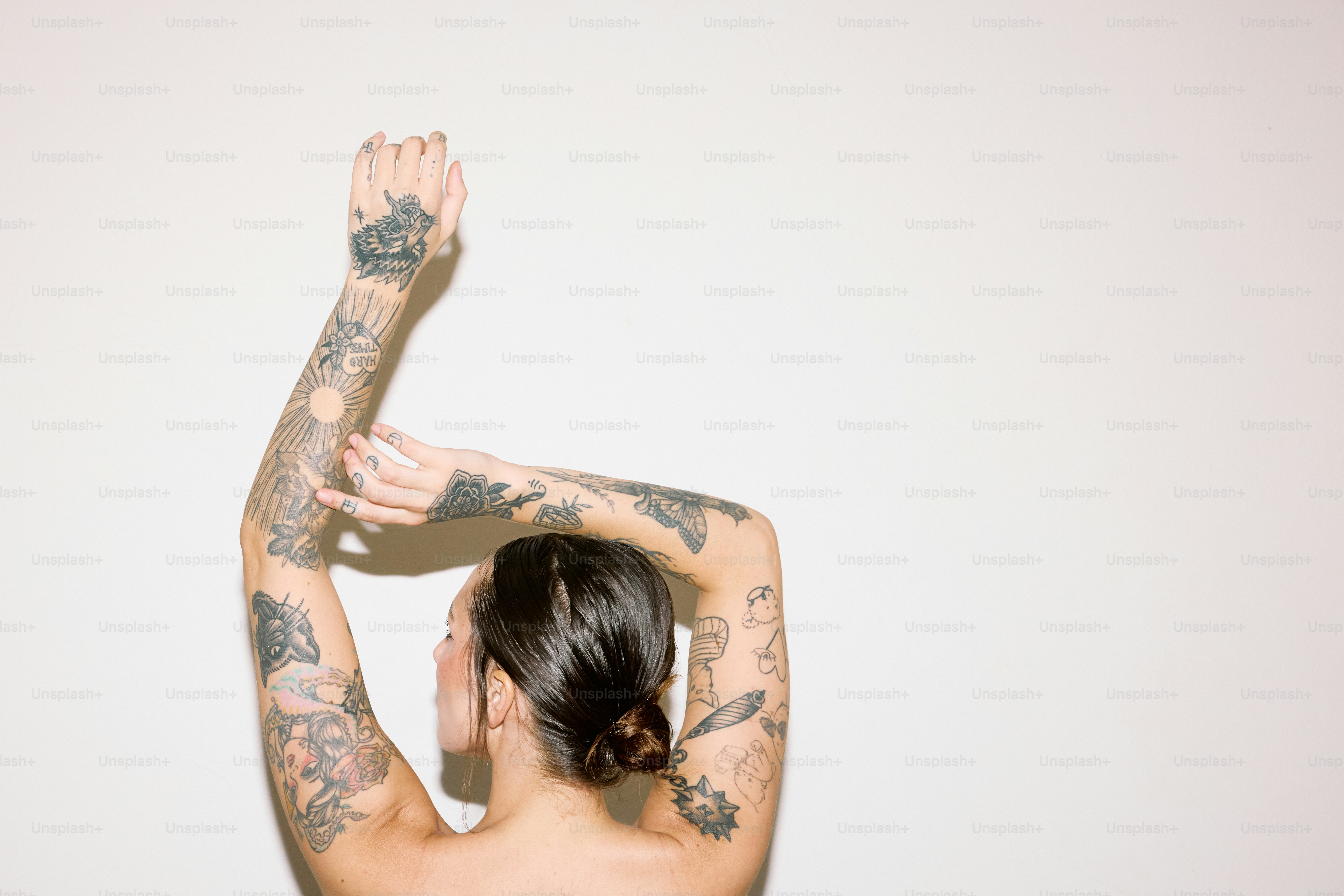a woman with tattoos on her arms and arms