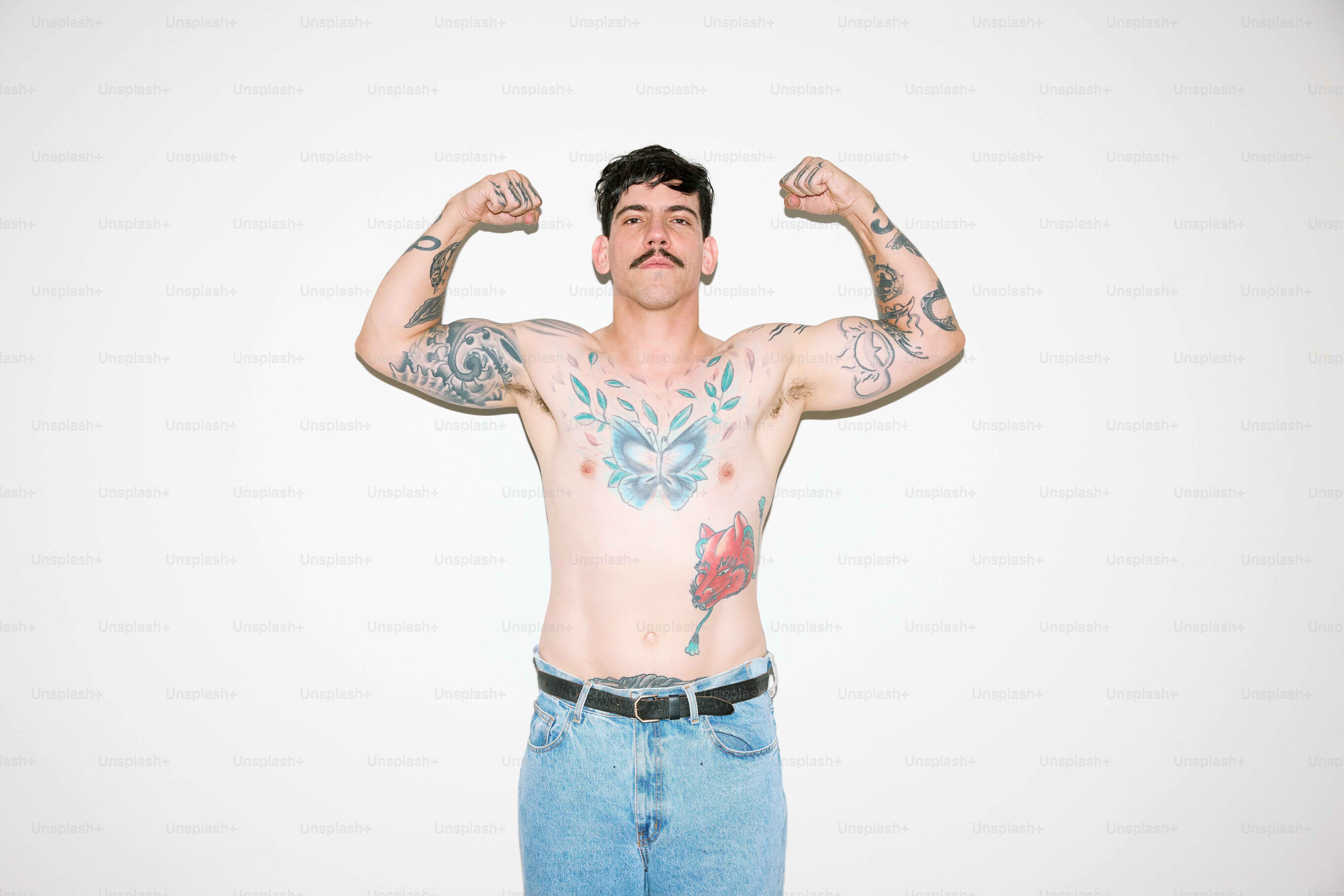 a man with tattoos on his arms and chest