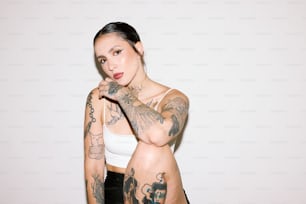 a woman with tattoos posing for a picture