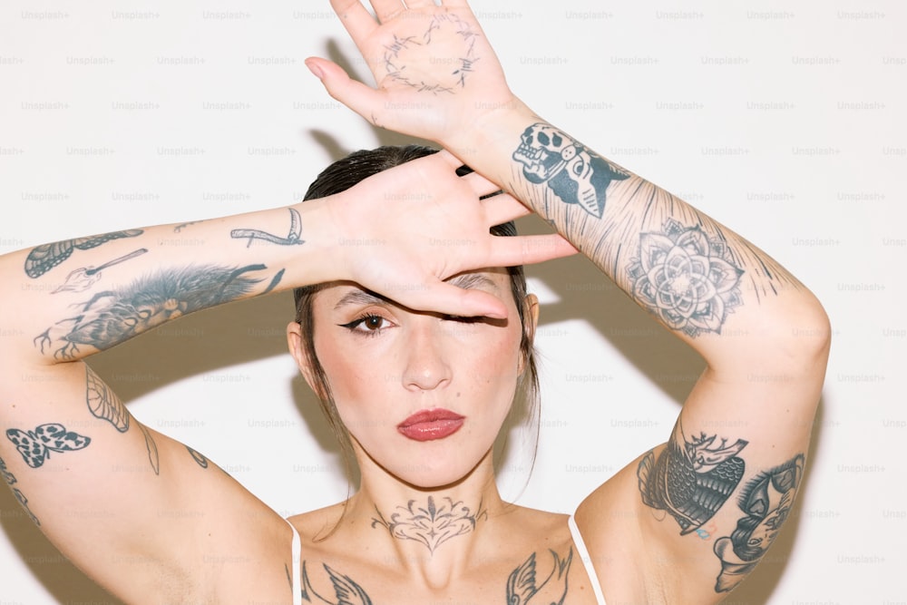 a woman with tattoos covering her face and hands