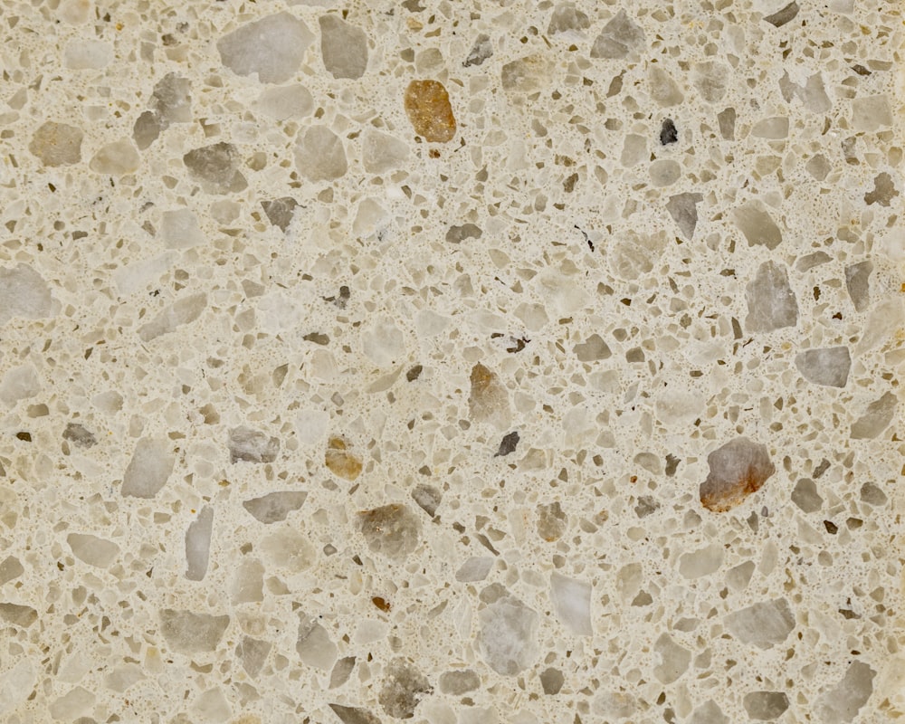 a close up of a marble surface with small rocks