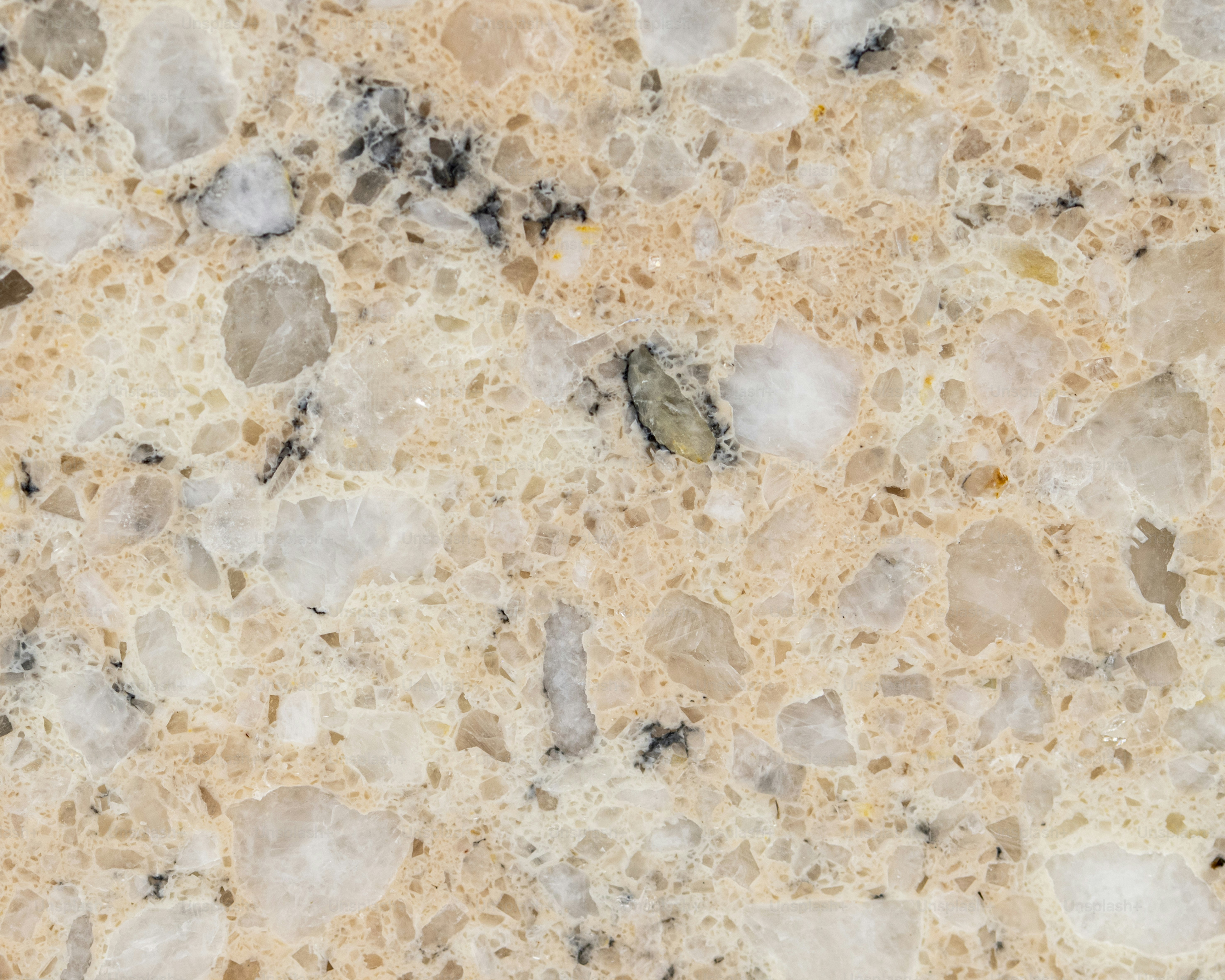 a close up of a marble surface with small rocks