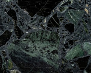 a close up of a black and green marble