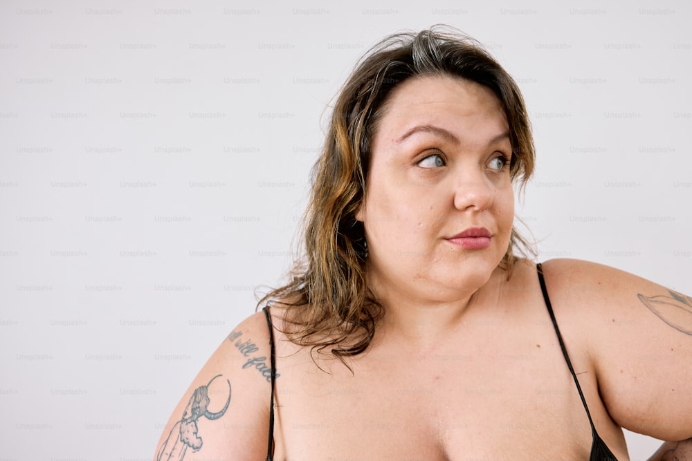 a woman in a black bikini posing for a picture