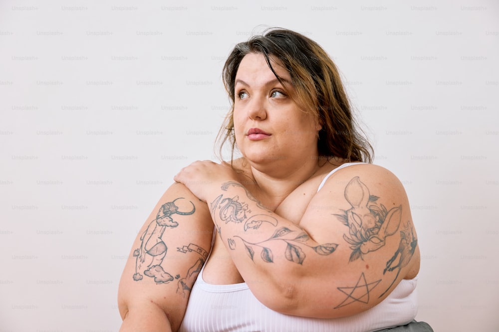 a woman with a lot of tattoos on her arms