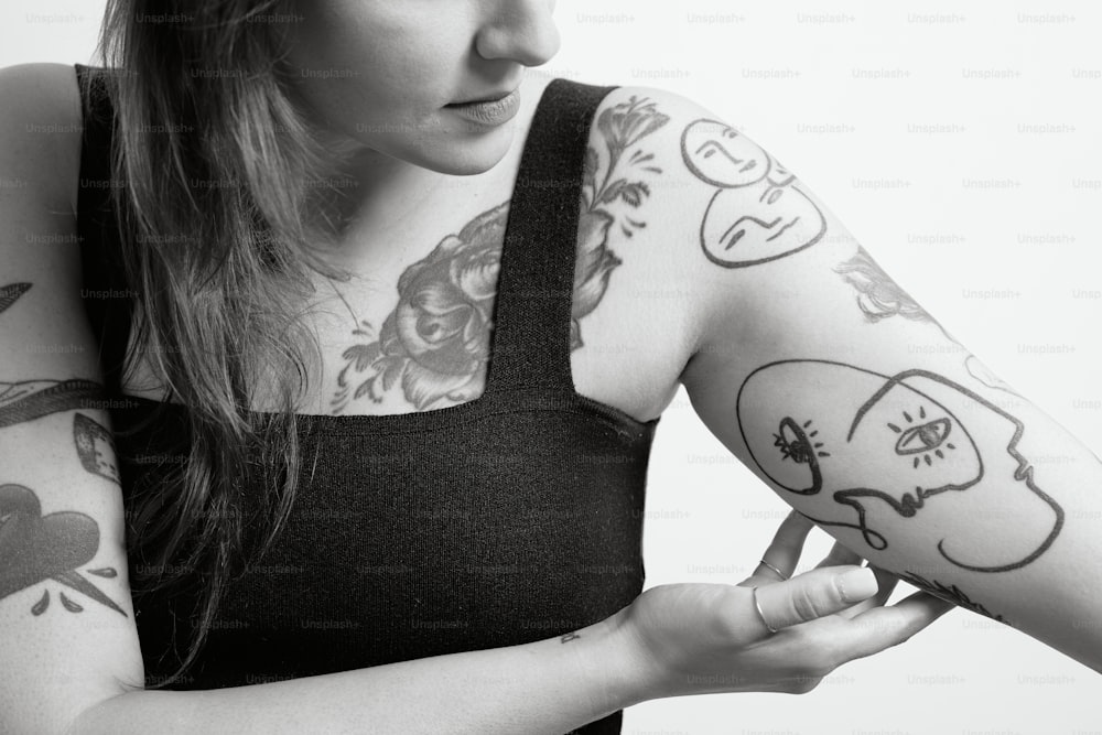 a woman with many tattoos on her arm