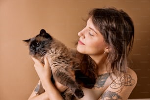 a woman holding a cat in her arms