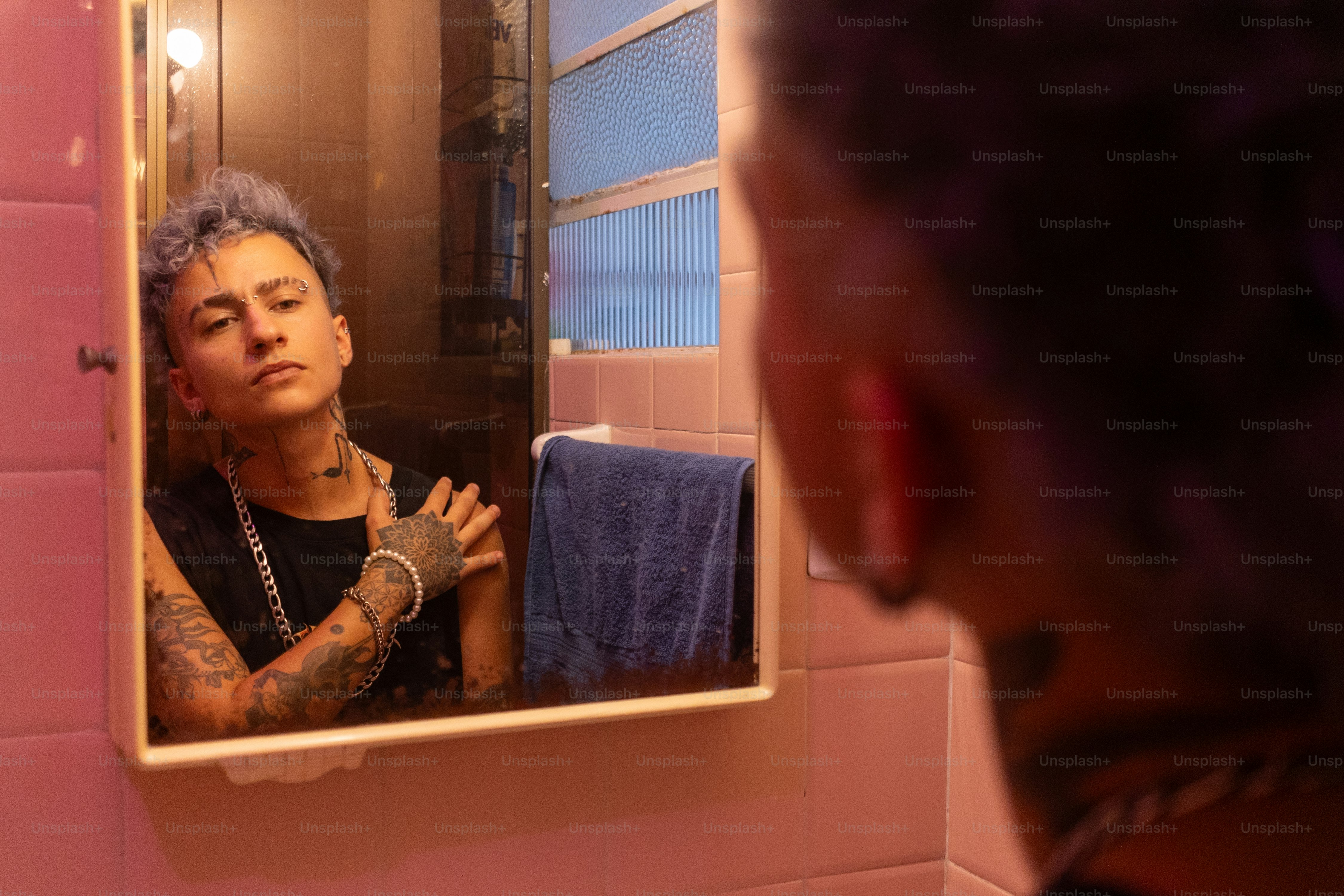 a woman looking at herself in the mirror