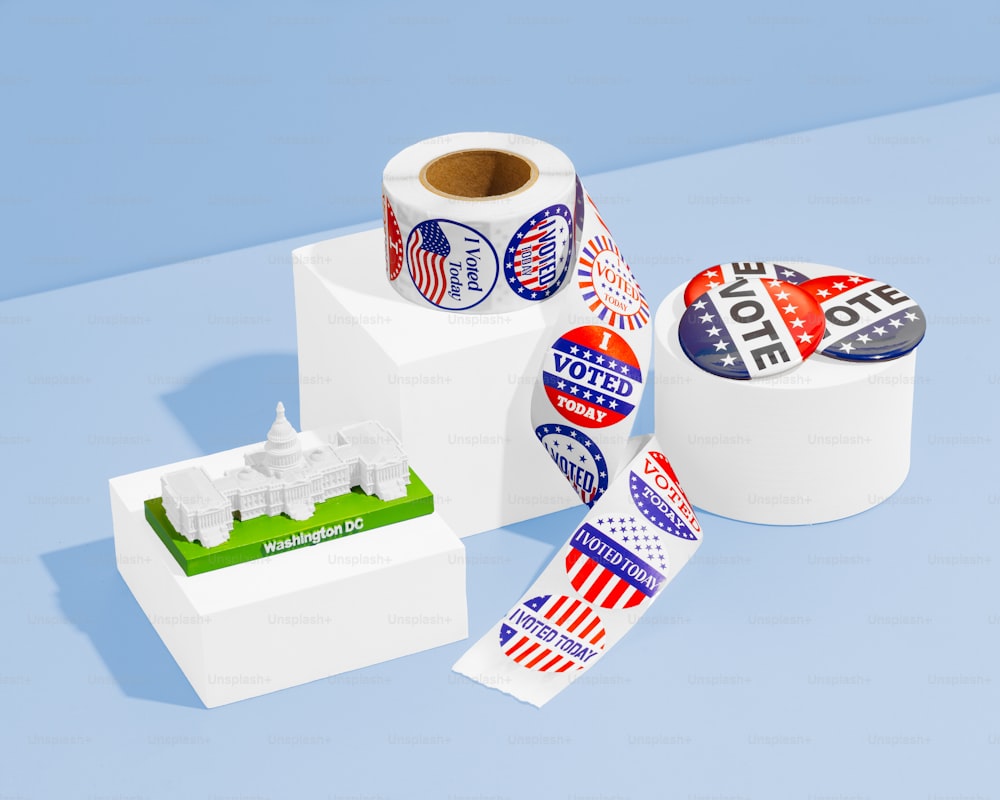 two rolls of political stickers next to a cup of coffee