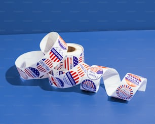 a pile of election stickers sitting on top of a blue table