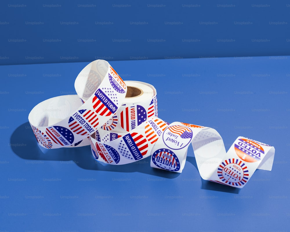 a pile of election stickers sitting on top of a blue table