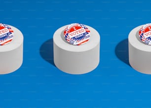 a group of three rolls of toilet paper on a blue background
