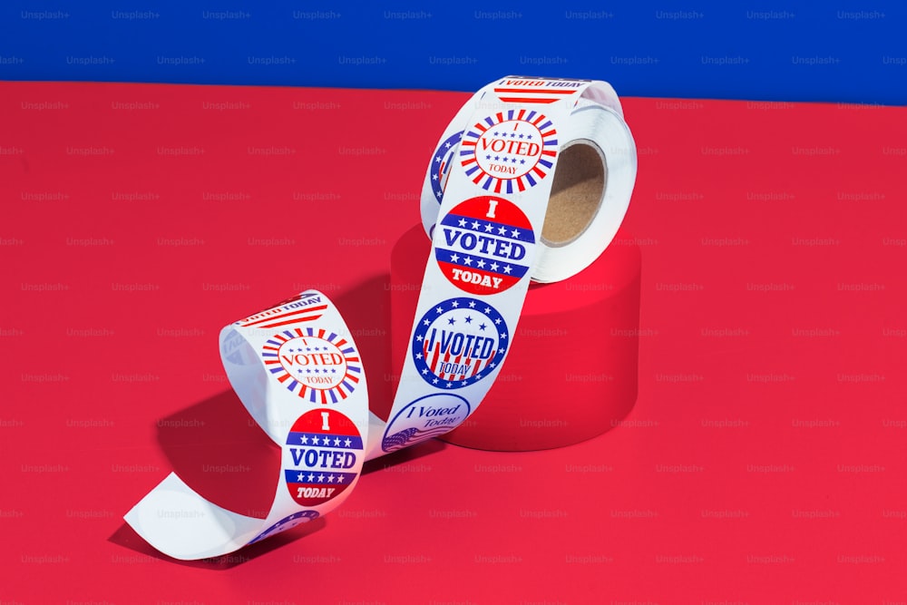 a roll of voting paper on a red surface