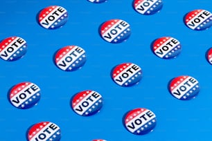 a group of political buttons on a blue background
