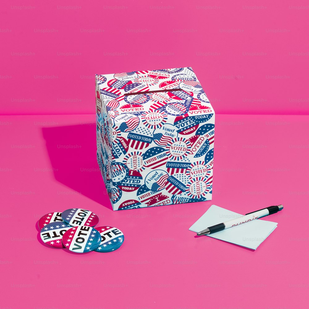 a pink background with a white box and two red, white, and blue patterned