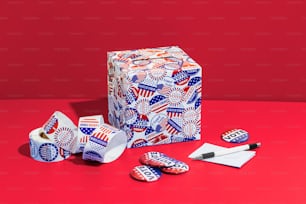 a red, white, and blue box with scissors and other items