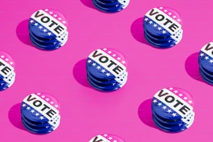 a group of buttons with the words vote on them