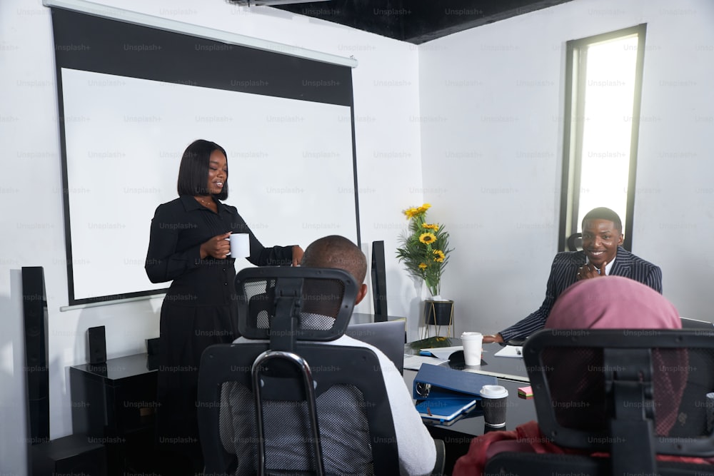 a woman giving a presentation to a group of people