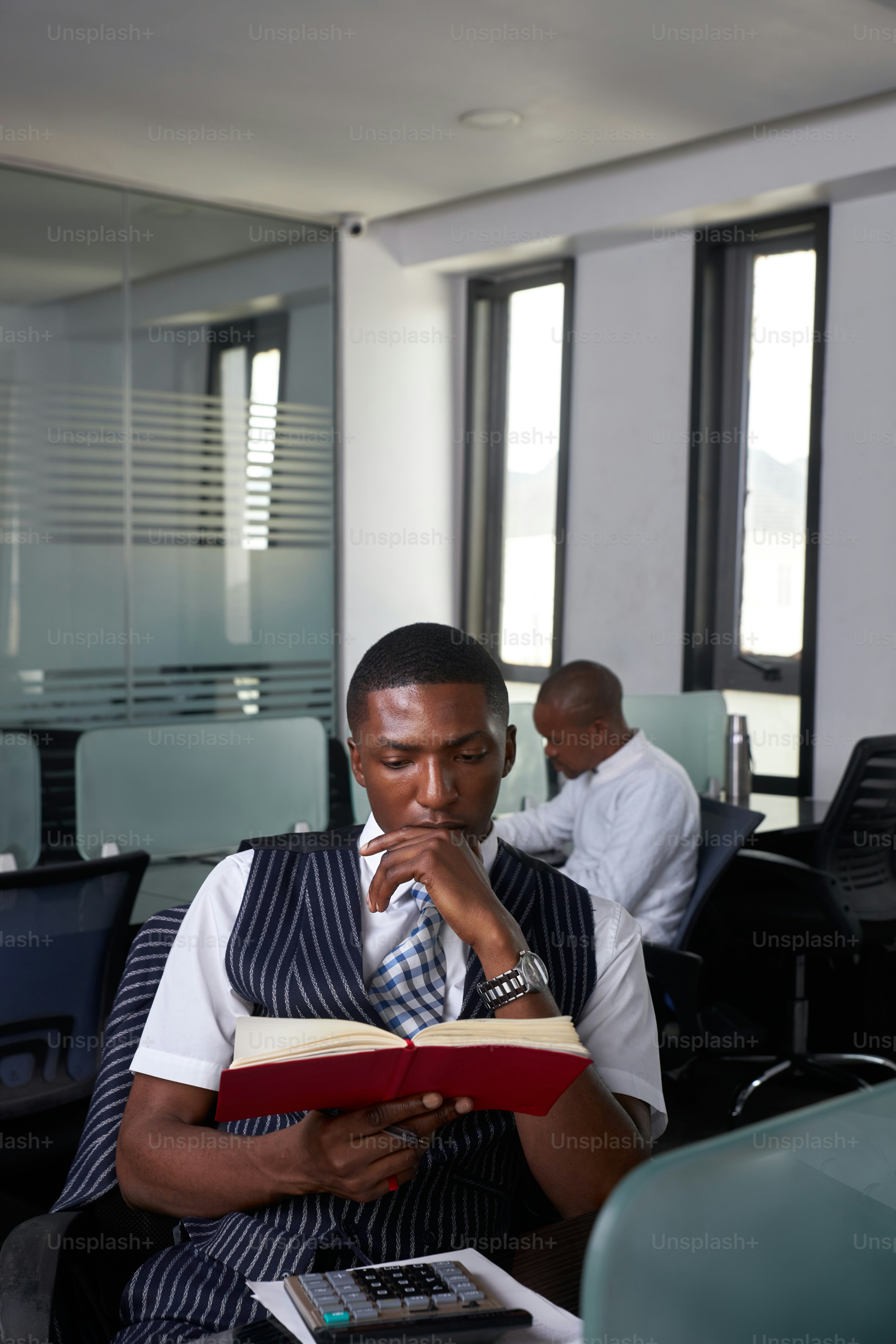 a man reading a book in an office