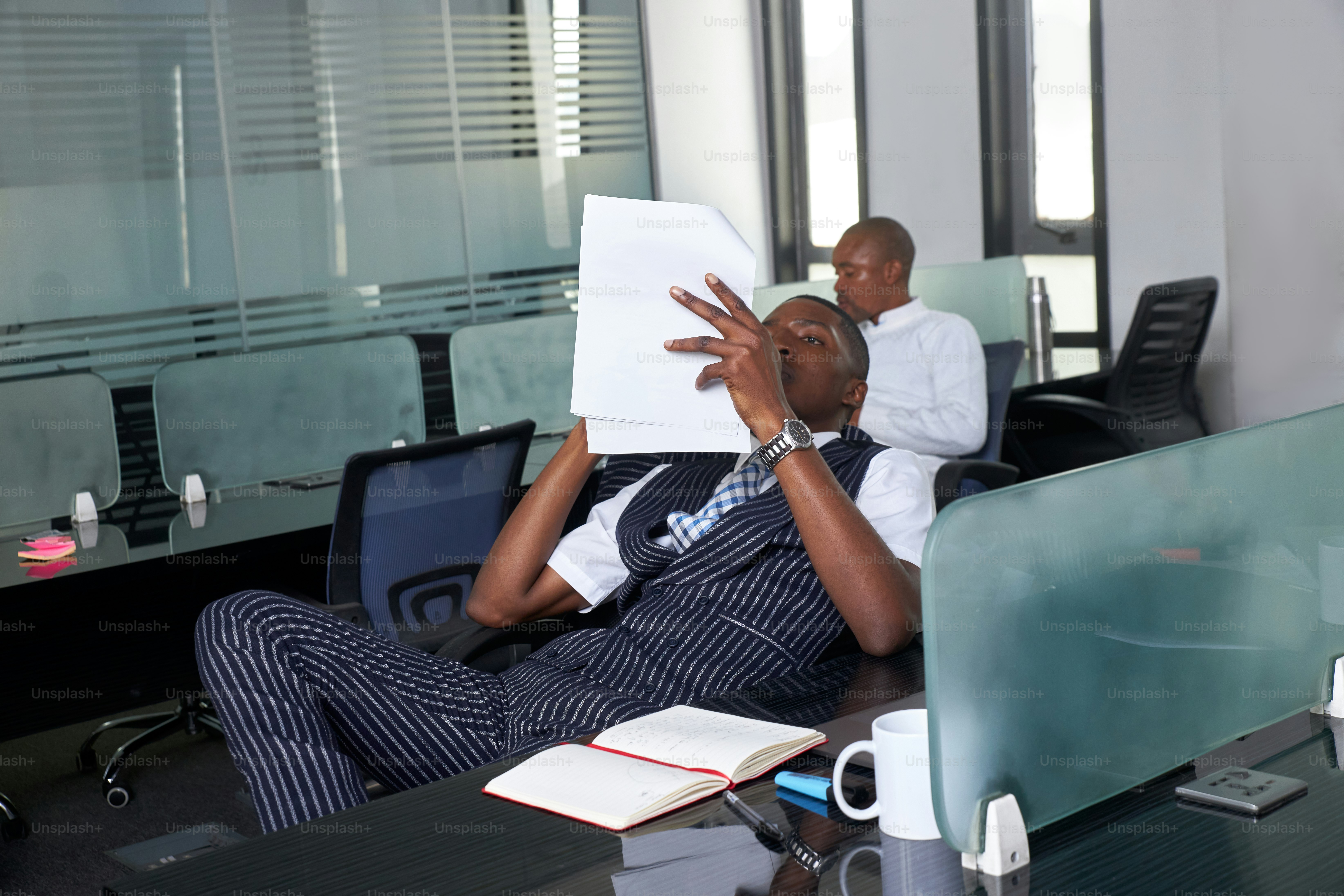 a couple of men sitting at a desk in an office