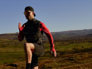 a man in a black and red outfit running