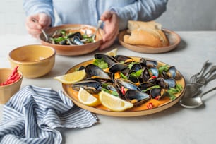 a plate of mussels and a bowl of salad