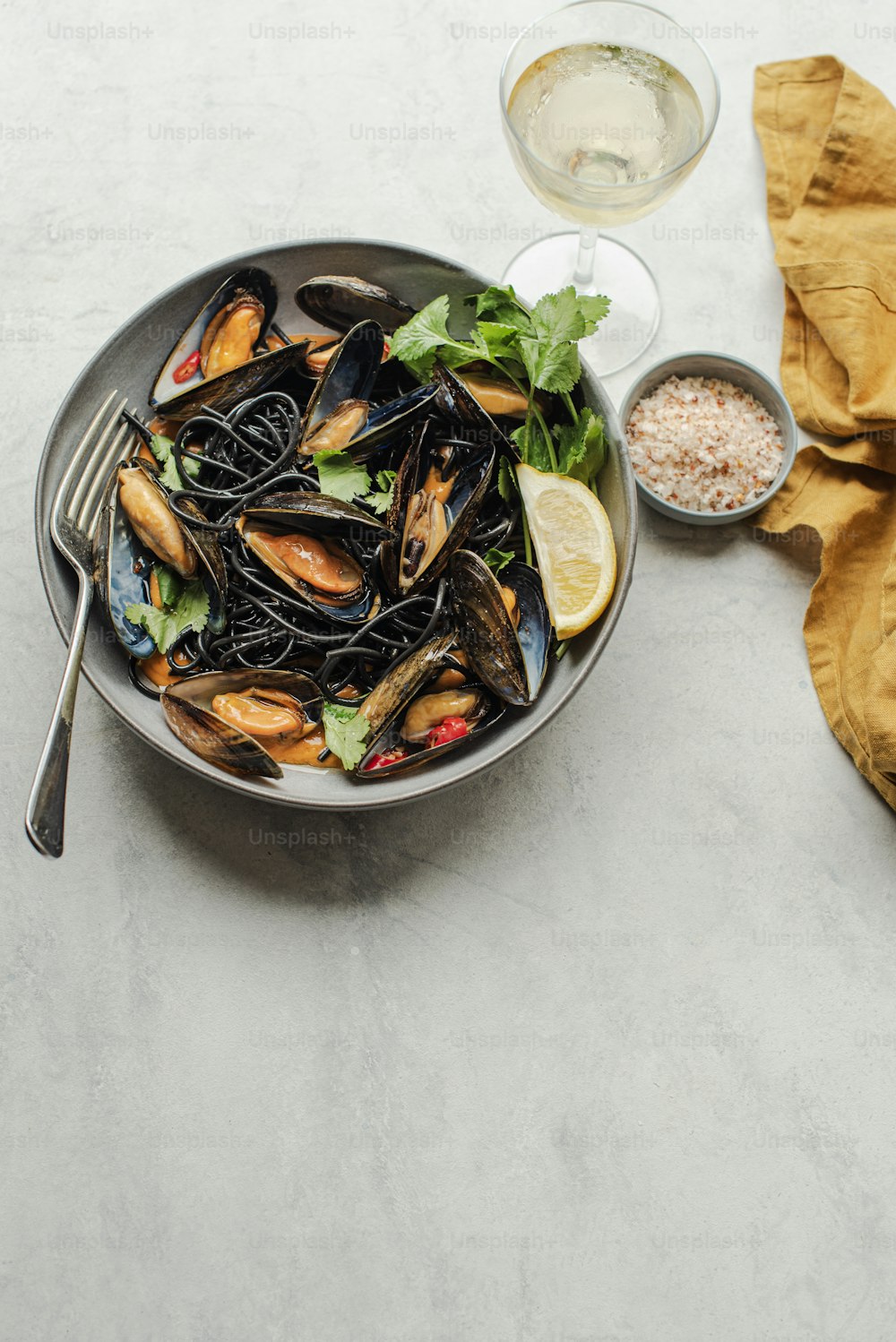 a bowl of mussels with a side of rice