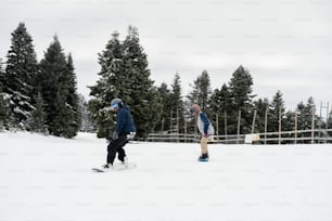 Un par de personas montando esquís por una ladera cubierta de nieve