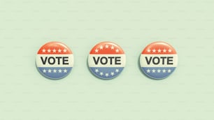 three buttons with the words vote on them